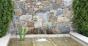 garden rock wall with pond