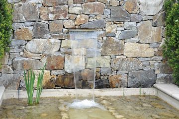 garden rock wall with pond
