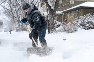 man shoveling snow in kelowna